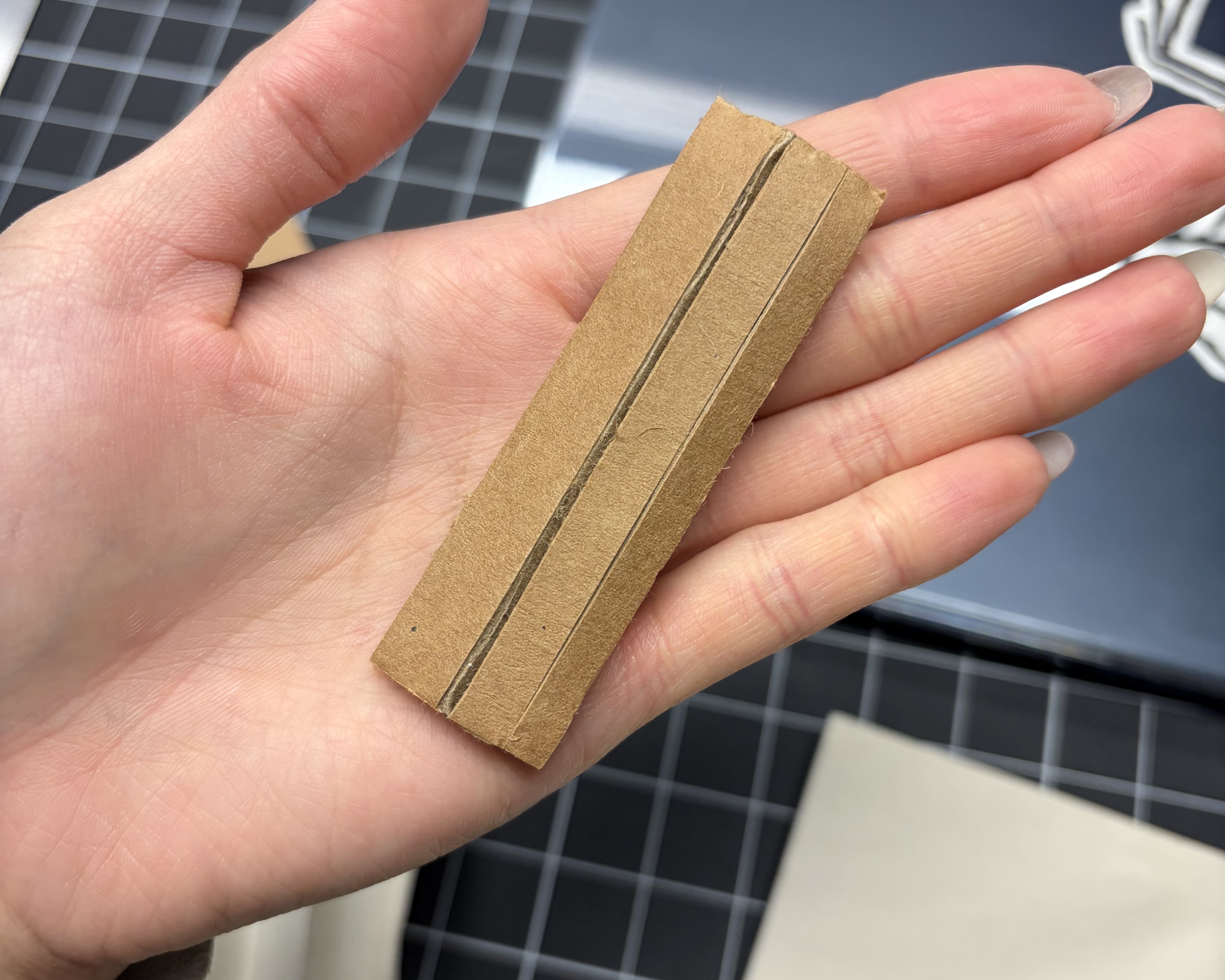 Scoring only the top layer of cardboard to make it more flexible